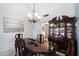 Formal dining room with a wood table, chandelier, and hutch at 9041 E Ludlow Dr, Scottsdale, AZ 85260