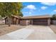 Single-story home with a two-car garage and attractive landscaping at 9041 E Ludlow Dr, Scottsdale, AZ 85260