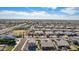 Expansive aerial view of a neighborhood featuring neatly planned homes and community spaces under a bright, sunny sky at 9144 W Sands Dr, Peoria, AZ 85383