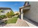 Well-maintained backyard featuring a covered patio, grassy area, and desert-friendly landscaping at 9144 W Sands Dr, Peoria, AZ 85383