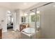 Well-lit bathroom featuring a soaking tub, a shower, and an open doorway at 9144 W Sands Dr, Peoria, AZ 85383