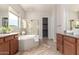 Bathroom showcasing soaking tub, shower, and dual sink vanity at 9144 W Sands Dr, Peoria, AZ 85383