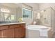 Bathroom boasts a large soaking tub, shower, and neutral-toned vanity at 9144 W Sands Dr, Peoria, AZ 85383