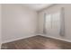 Bright bedroom with hardwood floors, neutral walls, and a large window at 9144 W Sands Dr, Peoria, AZ 85383