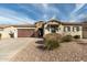 Charming home with a two-car garage, stone accents and low-maintenance desert landscaping at 9144 W Sands Dr, Peoria, AZ 85383