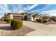 Attractive single-story home boasting a well-manicured desert landscape and a two-car garage at 9144 W Sands Dr, Peoria, AZ 85383