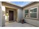 Inviting front porch with a unique water feature and view of the home's windows and entryway at 9144 W Sands Dr, Peoria, AZ 85383