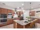 Modern kitchen featuring granite countertops, stainless steel appliances, and a convenient center island at 9144 W Sands Dr, Peoria, AZ 85383