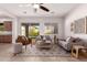 Cozy living area with neutral decor, tile floors, a ceiling fan, and a sliding glass door to the patio at 9144 W Sands Dr, Peoria, AZ 85383