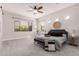 Bright main bedroom with carpet, ceiling fan, and large windows at 9144 W Sands Dr, Peoria, AZ 85383