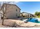 A spacious backyard with a diving board pool, complemented by low-maintenance landscaping at 9144 W Sands Dr, Peoria, AZ 85383