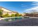 Backyard pool and brick paver deck, surrounded by greenery and mature landscaping at 9144 W Sands Dr, Peoria, AZ 85383