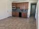 Wet bar with wood cabinets and tile flooring at 9144 W Sands Dr, Peoria, AZ 85383