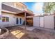 Private backyard with covered patio, storage shed, and rocking chair at 944 S Valencia -- # 3, Mesa, AZ 85202