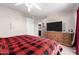 Bedroom with a large TV, dresser, and ceiling fan at 944 S Valencia -- # 3, Mesa, AZ 85202