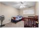 Bedroom with twin bed, crib, ceiling fan, and window at 944 S Valencia -- # 3, Mesa, AZ 85202