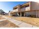 Tan townhome with walkway and landscaping, sunny exterior at 944 S Valencia -- # 3, Mesa, AZ 85202