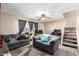 Living room with gray sofas, ceiling fan, and stairs at 944 S Valencia -- # 3, Mesa, AZ 85202