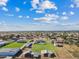 Aerial view of property with a house, pool, and large pasture at 9449 S 156Th Pl, Gilbert, AZ 85234