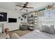 Bedroom with a bed, beanbag chair, and shelving unit at 9449 S 156Th Pl, Gilbert, AZ 85234