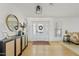 Bright and airy entryway with hardwood floors and a large mirror at 9449 S 156Th Pl, Gilbert, AZ 85234