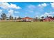 Image of an equestrian facility with a covered arena and barns at 9449 S 156Th Pl, Gilbert, AZ 85234