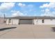 Two-car garage with gray door, attached to a white brick home at 9449 S 156Th Pl, Gilbert, AZ 85234