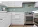 Modern kitchen with stainless steel appliances and white cabinets at 9449 S 156Th Pl, Gilbert, AZ 85234