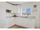 Bright and airy kitchen with white cabinetry, granite countertops, and a stylish backsplash at 9449 S 156Th Pl, Gilbert, AZ 85234