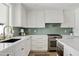 Modern kitchen with white cabinets, quartz countertops, and stainless steel appliances at 9449 S 156Th Pl, Gilbert, AZ 85234