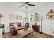 Cozy living room featuring a brown leather sofa and wooden coffee table at 9449 S 156Th Pl, Gilbert, AZ 85234