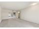 Spacious living room with carpeted floors and neutral color palette at 9506 W Greenhurst Dr, Sun City, AZ 85351