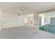 Bright living room with sliding glass doors leading to a patio at 9506 W Greenhurst Dr, Sun City, AZ 85351