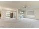 Living room with view of kitchen and access to patio at 9506 W Greenhurst Dr, Sun City, AZ 85351