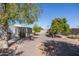 Spacious backyard with gravel, trees, and patio at 9533 W Cedar Hill N Cir, Sun City, AZ 85351