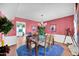 Dining room with a glass-top table and pink walls at 9533 W Cedar Hill N Cir, Sun City, AZ 85351