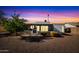 Ranch-style home exterior with screened patio at sunset at 9533 W Cedar Hill N Cir, Sun City, AZ 85351