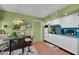 Bright kitchen with white cabinets, teal accents, and tile floor at 9533 W Cedar Hill N Cir, Sun City, AZ 85351