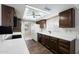 Galley-style kitchen with wood cabinets and white countertops at 1000 Leisure World --, Mesa, AZ 85206