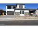 Two-story home with gray exterior, dark brown garage door, and stone accents at 1006 W Superstition Ct, Queen Creek, AZ 85140