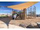 Modern playground with climbing structures and shade sail at 1006 W Superstition Ct, Queen Creek, AZ 85140