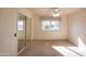 Bedroom with mirrored closet doors and neutral carpeting at 10114 W Campana Dr, Sun City, AZ 85351