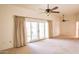 Spacious living area with sliding glass doors and ceiling fan at 10114 W Campana Dr, Sun City, AZ 85351