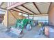 Hay bales and tractor in barn at 10137 N White Rd, Maricopa, AZ 85139