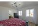 Main bedroom with large windows, chandelier and ensuite bath at 10137 N White Rd, Maricopa, AZ 85139