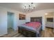 Spacious bedroom with a large bed, chandelier, and access to the bathroom at 10137 N White Rd, Maricopa, AZ 85139