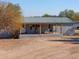 Ranch style home with covered porch and metal roof at 10137 N White Rd, Maricopa, AZ 85139