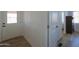 Bright hallway with light flooring and white doors at 10137 N White Rd, Maricopa, AZ 85139