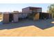 Hay storage barn with covered area and additional storage containers at 10137 N White Rd, Maricopa, AZ 85139