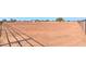 View of a large horse corral with metal fencing, dirt ground, and shadows at 10137 N White Rd, Maricopa, AZ 85139